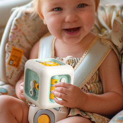 Bébé joyeux avec son cube d'activité sensoriel évolutif.
