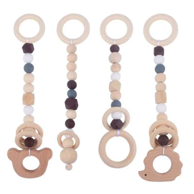 Jouet pour arche d'éveil bébé en bois de hêtre avec des motifs de couleur gris, blanc et marron.